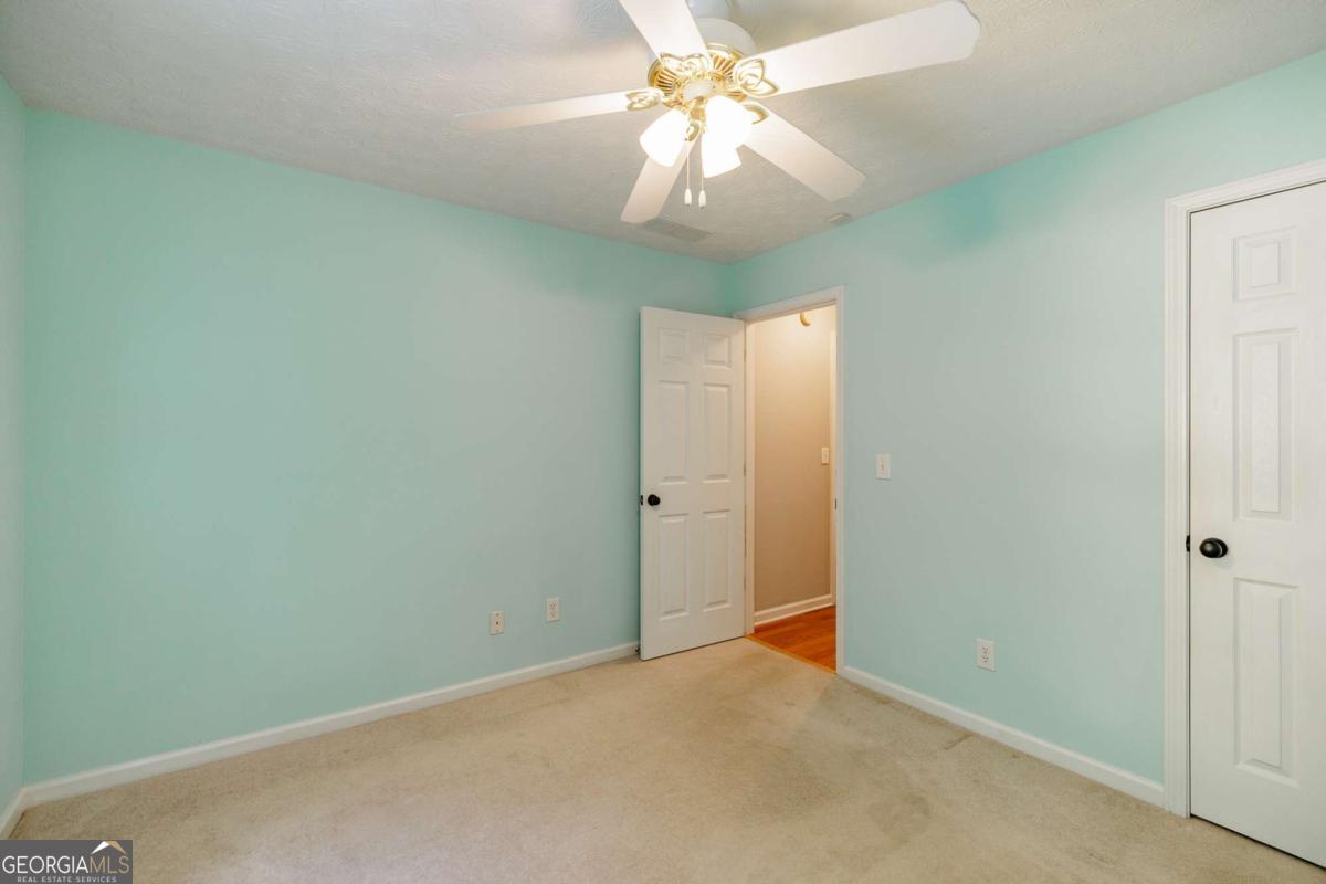 2249 Cluster Lane Grayson, GA 30017 - Photo 27 of 53 an empty room with a chandelier fan and closet
