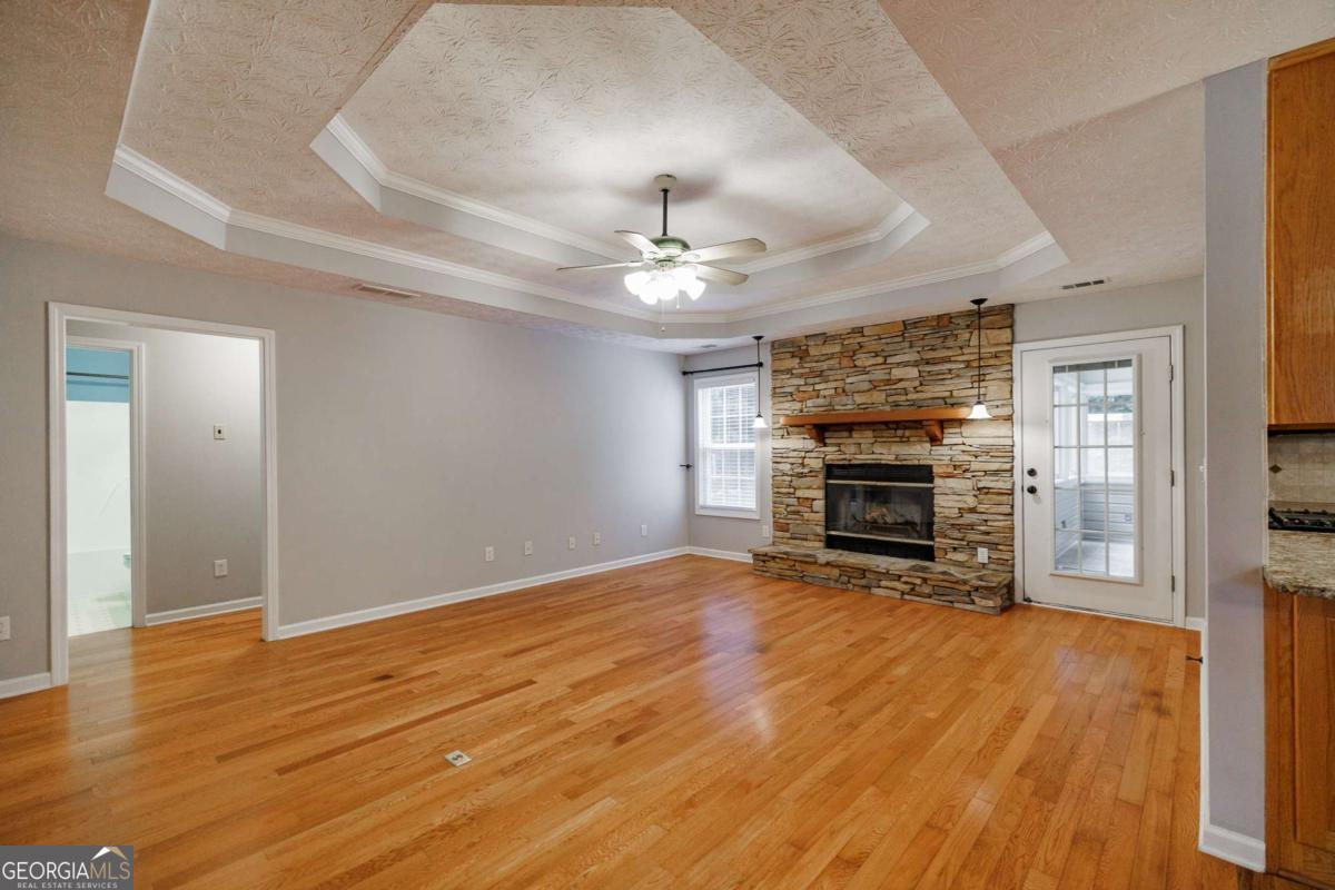 2249 Cluster Lane Grayson, GA 30017 - Photo 8 of 53 wooden floor in an empty room with a fireplace