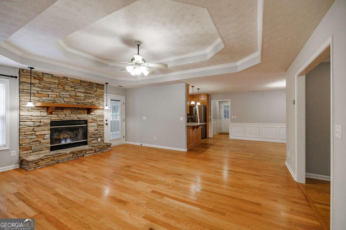 2249 Cluster Lane Grayson, GA 30017 - Photo 10 of 53 a view of an empty room with a fireplace and a chandelier