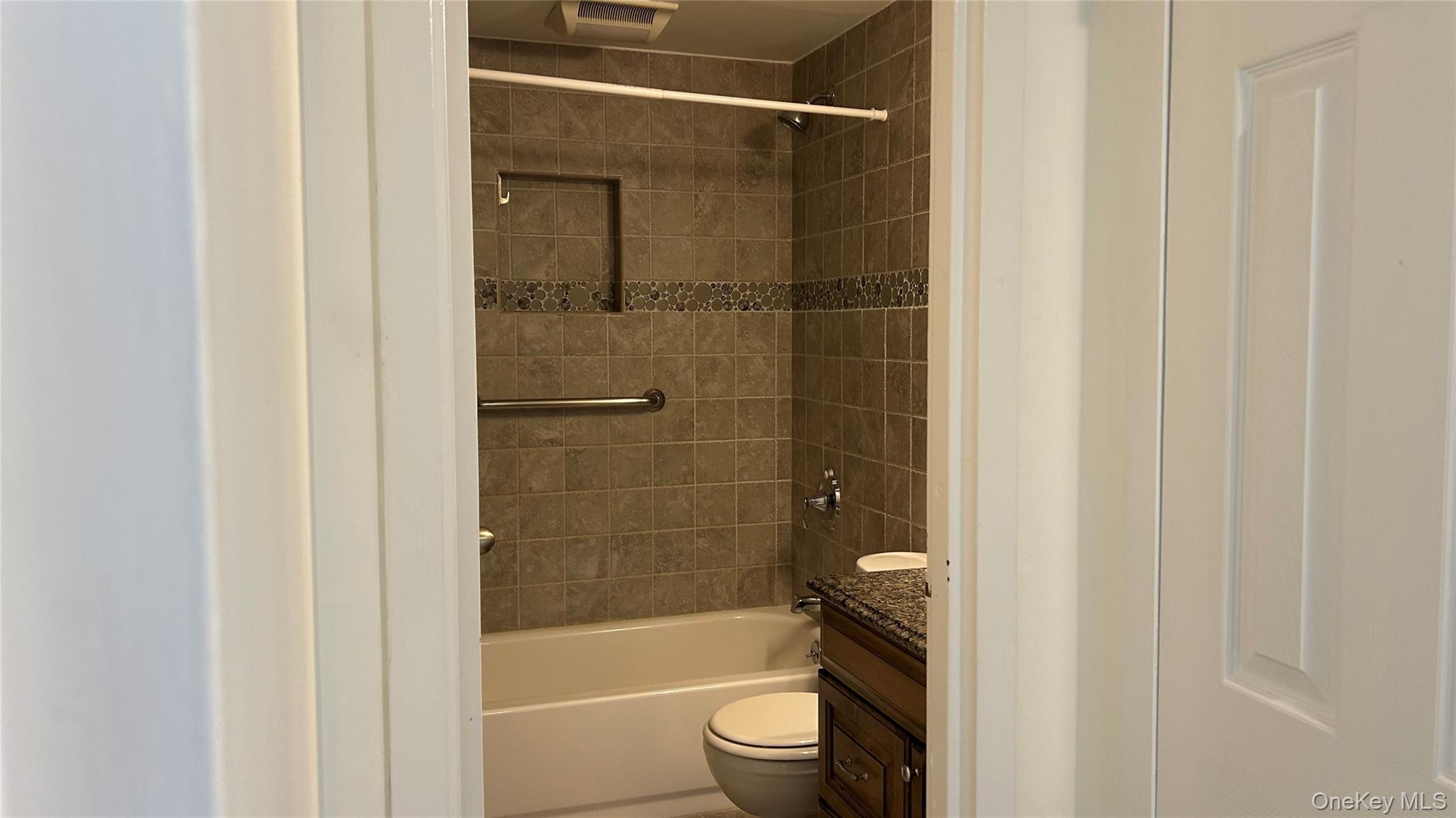 103 Birchwood Road, Unit 103 Medford, NY 11763 - Photo 12 of 13 a bathroom with a bathtub and a shower