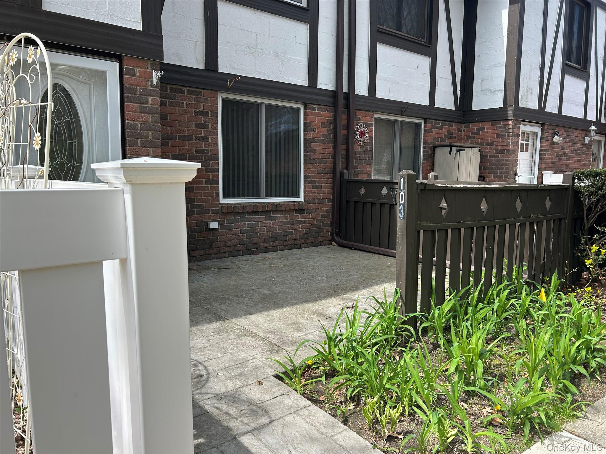 103 Birchwood Road, Unit 103 Medford, NY 11763 - Photo 2 of 13 a view of a house with a small yard and plants