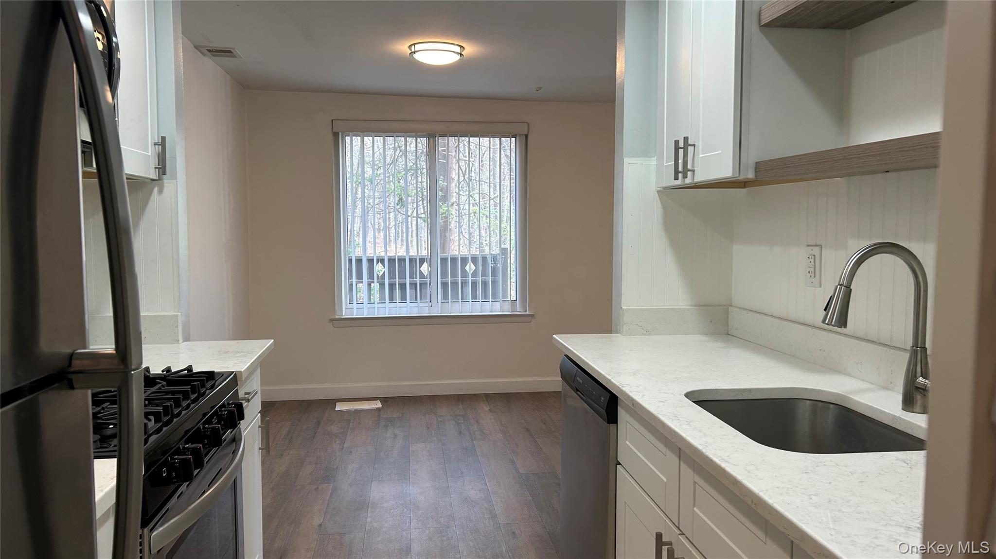 103 Birchwood Road, Unit 103 Medford, NY 11763 - Photo 3 of 13 a kitchen with a stove and a sink