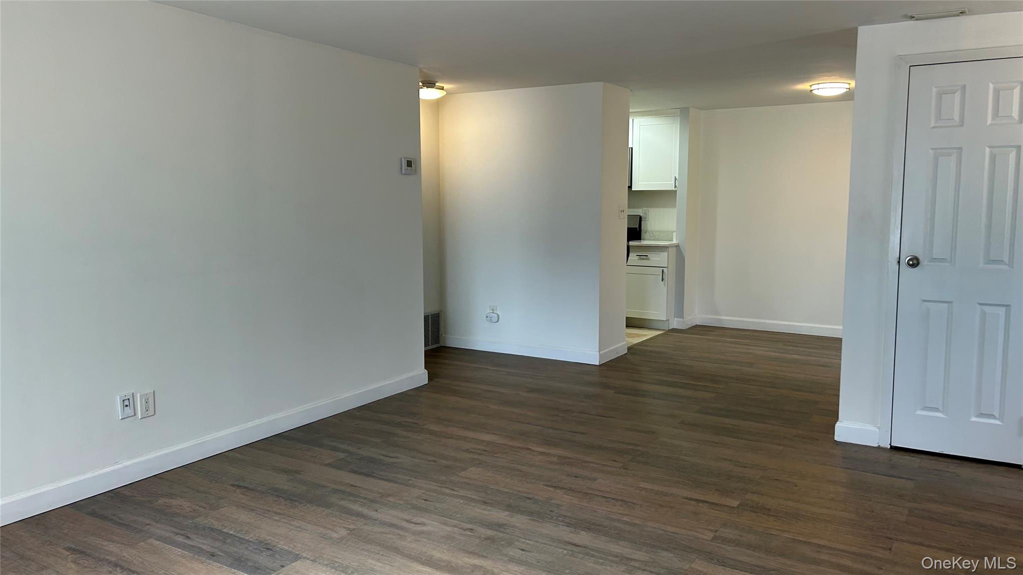 103 Birchwood Road, Unit 103 Medford, NY 11763 - Photo 7 of 13 a view of an empty room with wooden floor and closet area