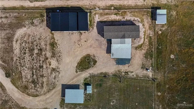 a view of a backyard with plants and outdoor seating