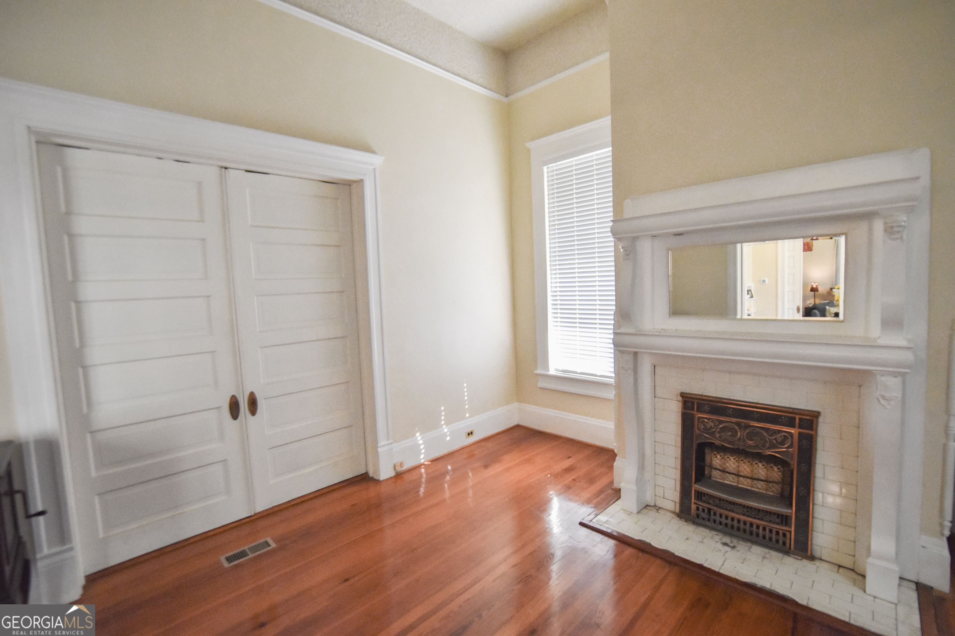 802 Mulberry Street Louisville, GA 30434 - Photo 11 of 51 a view of a livingroom with wooden floor and a fireplace