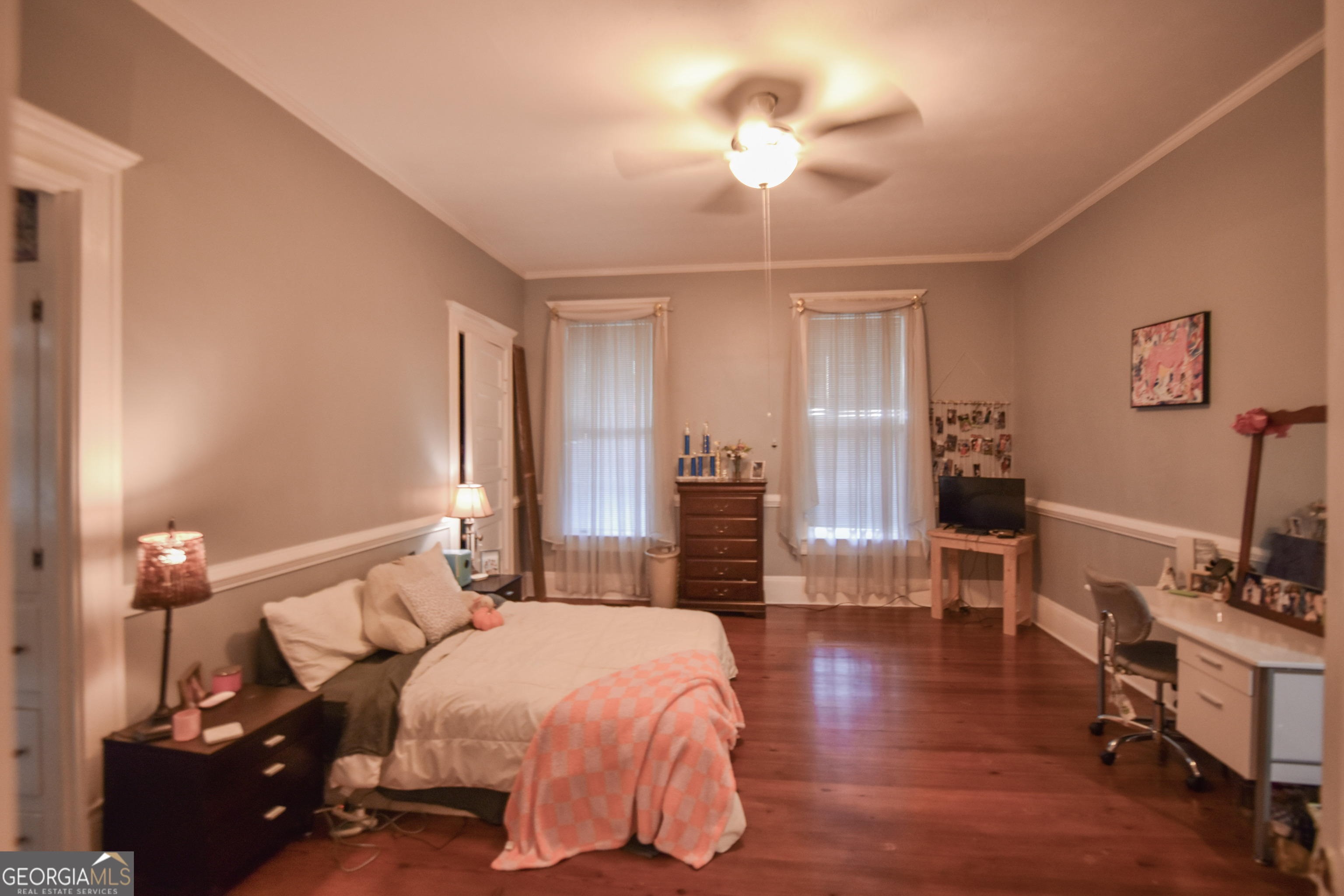 802 Mulberry Street Louisville, GA 30434 - Photo 20 of 51 a bedroom with a bed and wooden floor