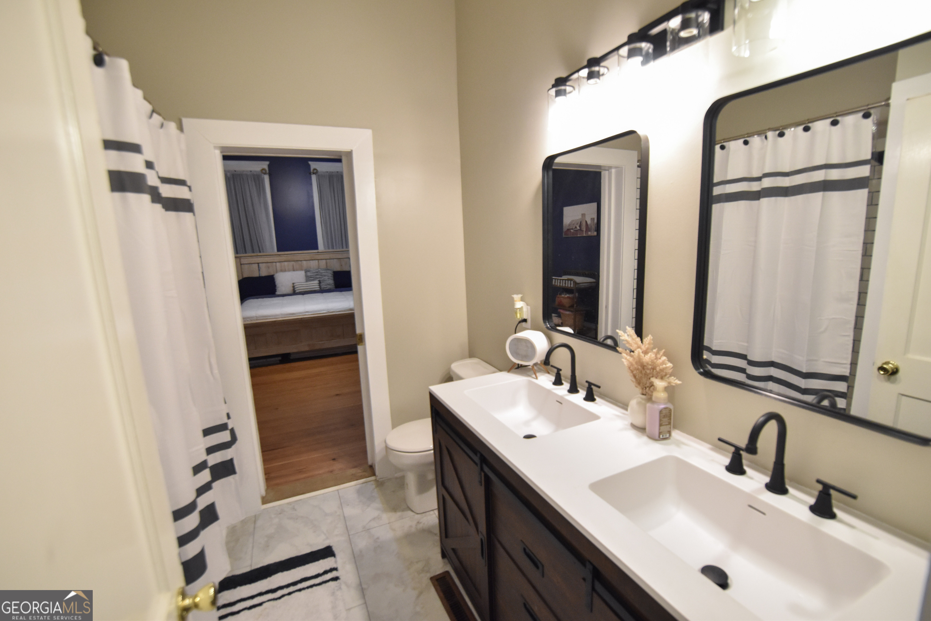 802 Mulberry Street Louisville, GA 30434 - Photo 21 of 51 a bathroom with a sink and a mirror