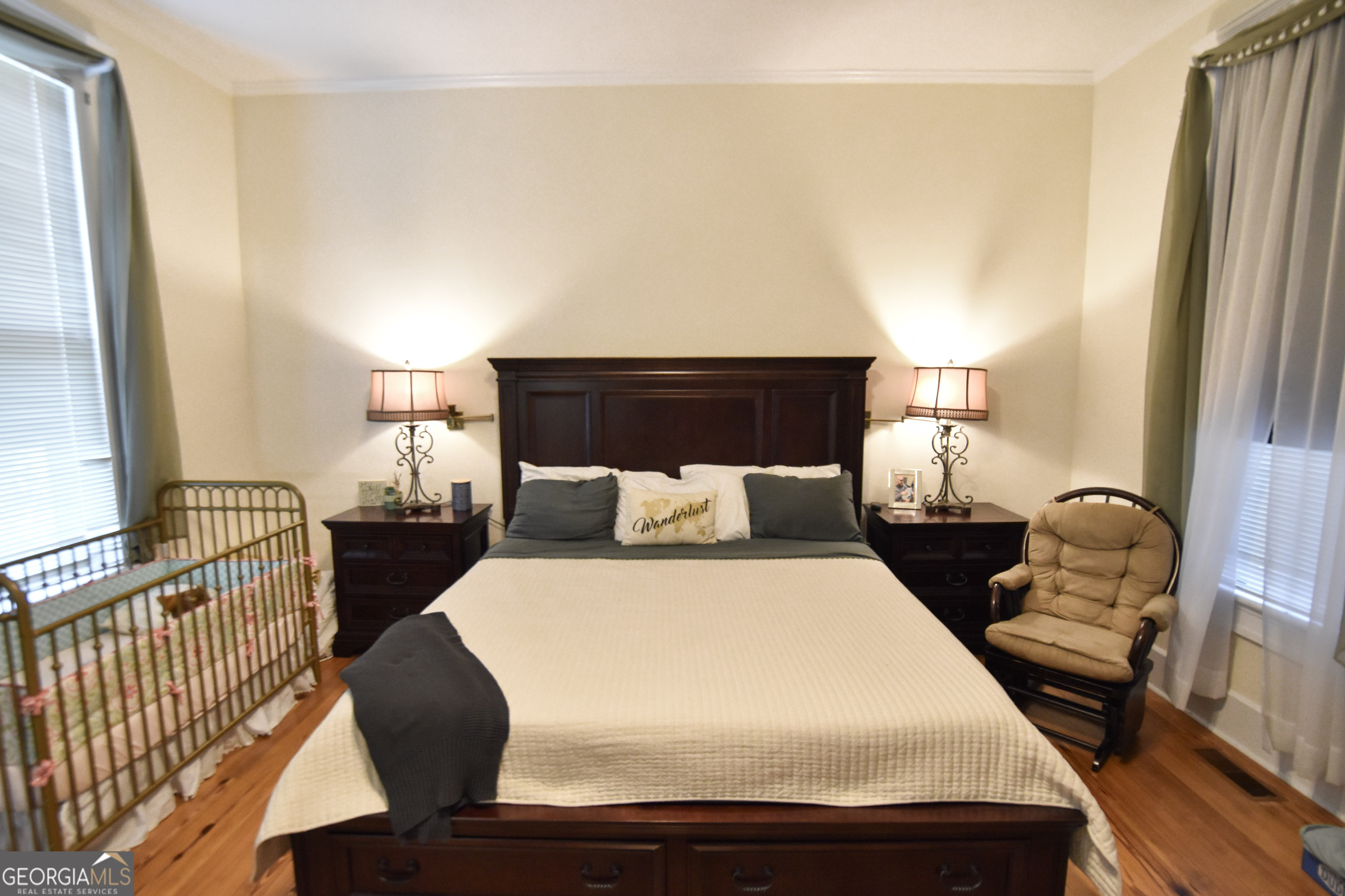 802 Mulberry Street Louisville, GA 30434 - Photo 28 of 51 a large bed sitting in a bedroom next to a window with pc on the table