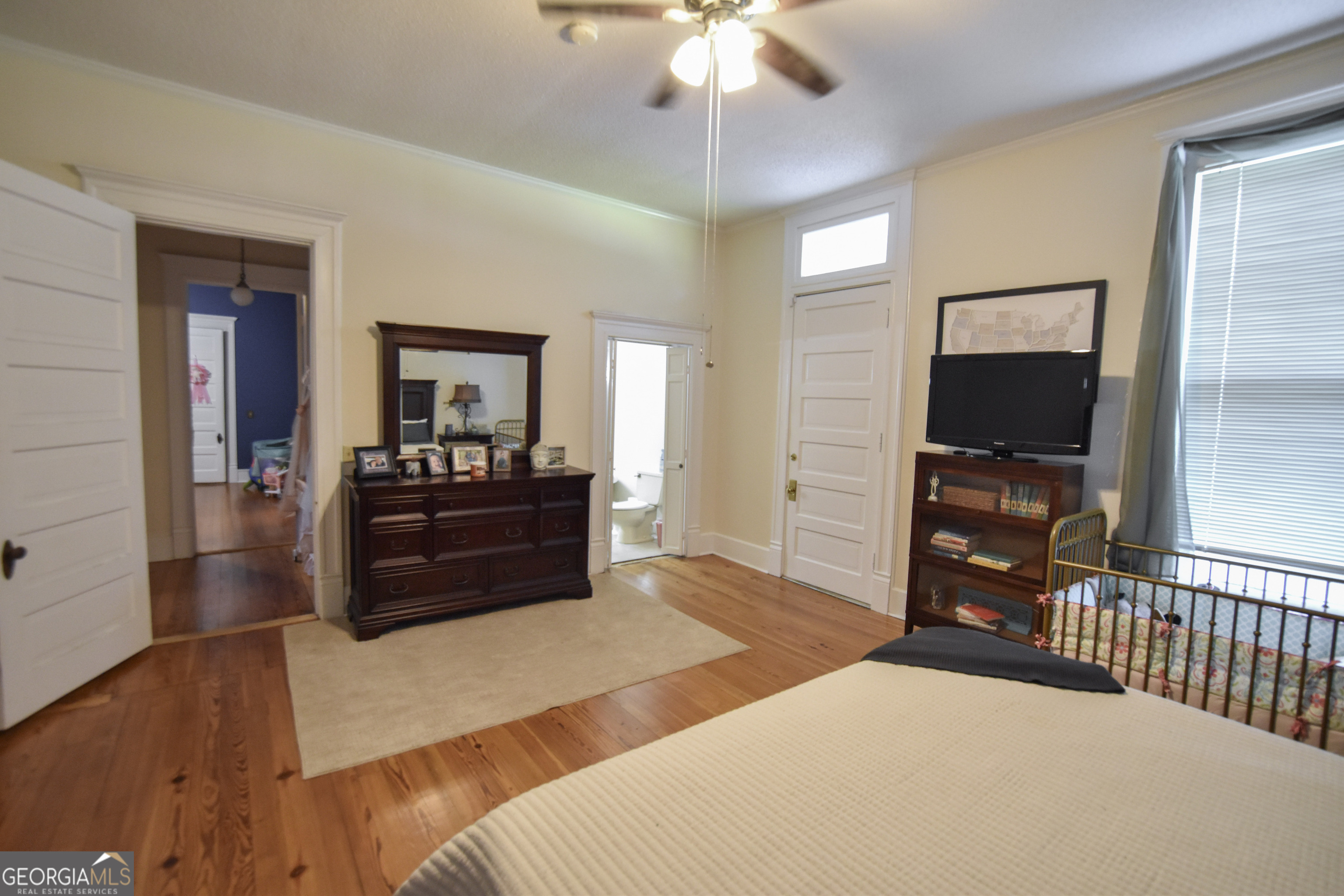 802 Mulberry Street Louisville, GA 30434 - Photo 29 of 51 a bedroom with a bed and a flat tv screen on dresser