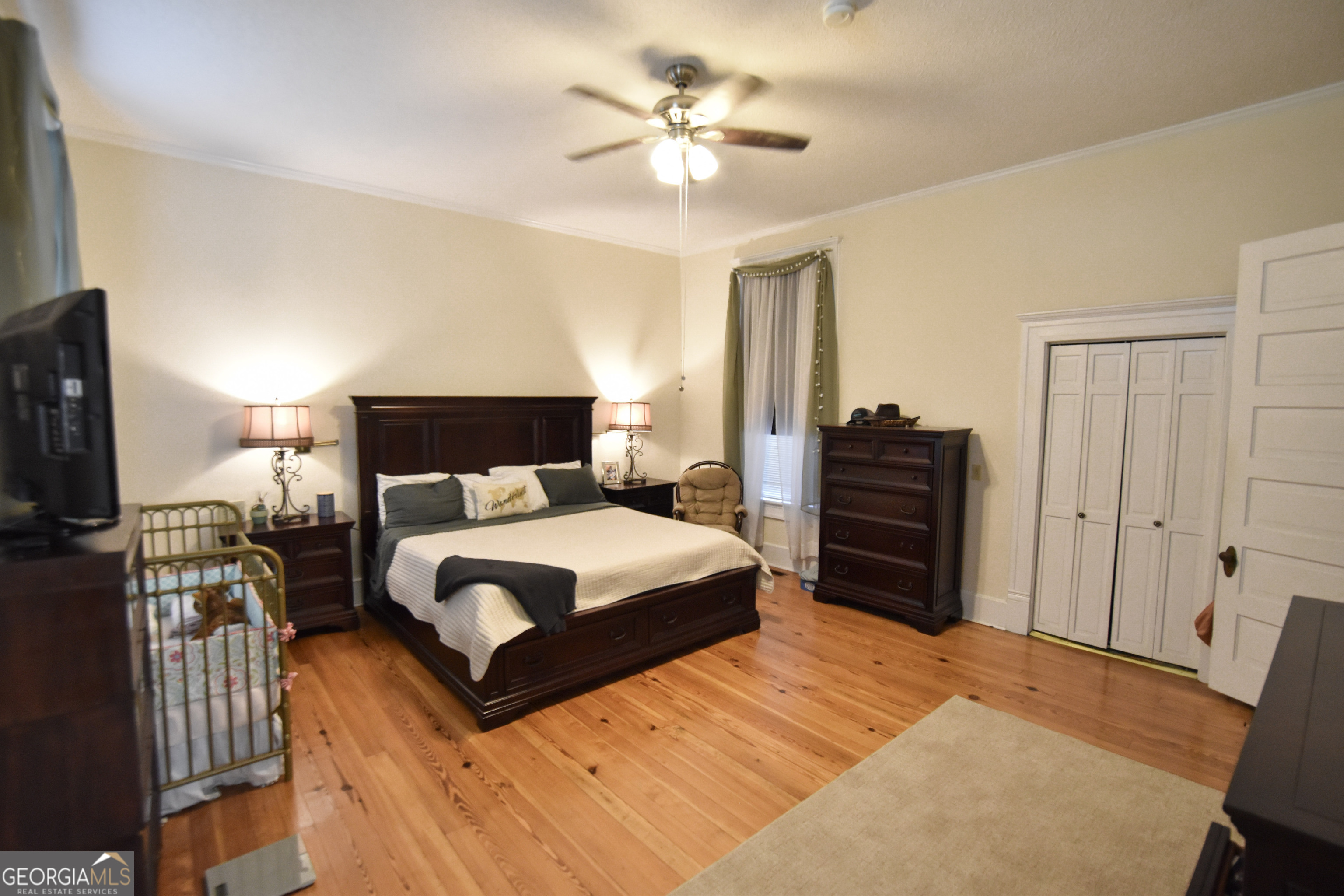 802 Mulberry Street Louisville, GA 30434 - Photo 30 of 51 a bedroom with a bed and a chandelier