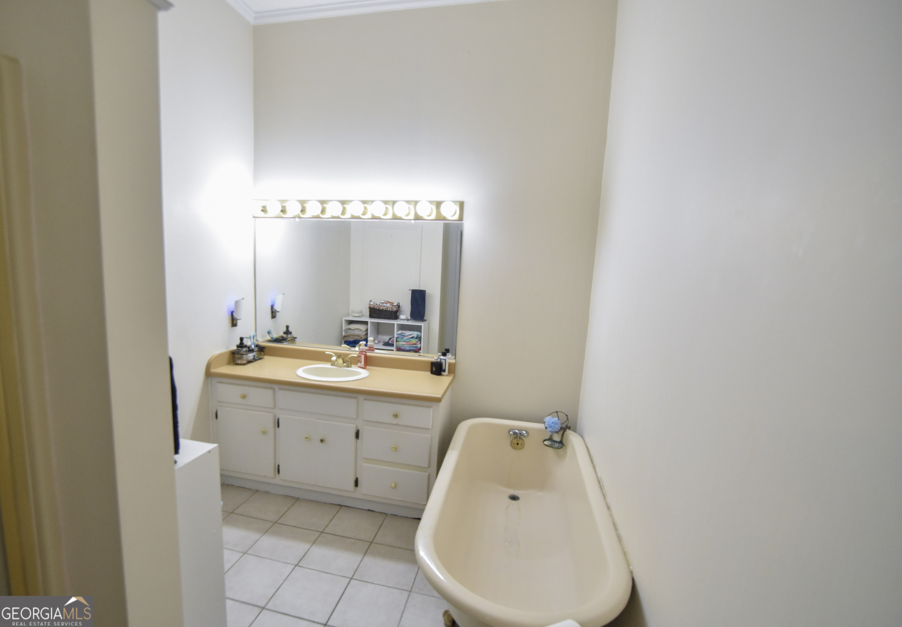 802 Mulberry Street Louisville, GA 30434 - Photo 31 of 51 a en suite bathroom with a granite countertop sink and a mirror