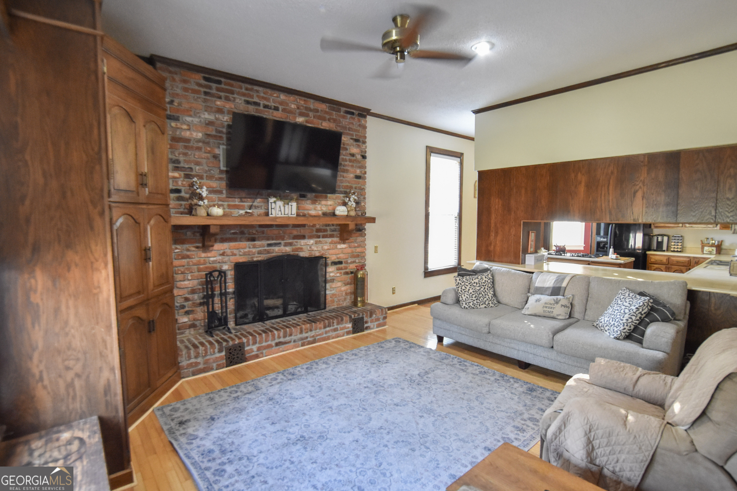 802 Mulberry Street Louisville, GA 30434 - Photo 34 of 51 a living room with furniture a flat screen tv and a fireplace