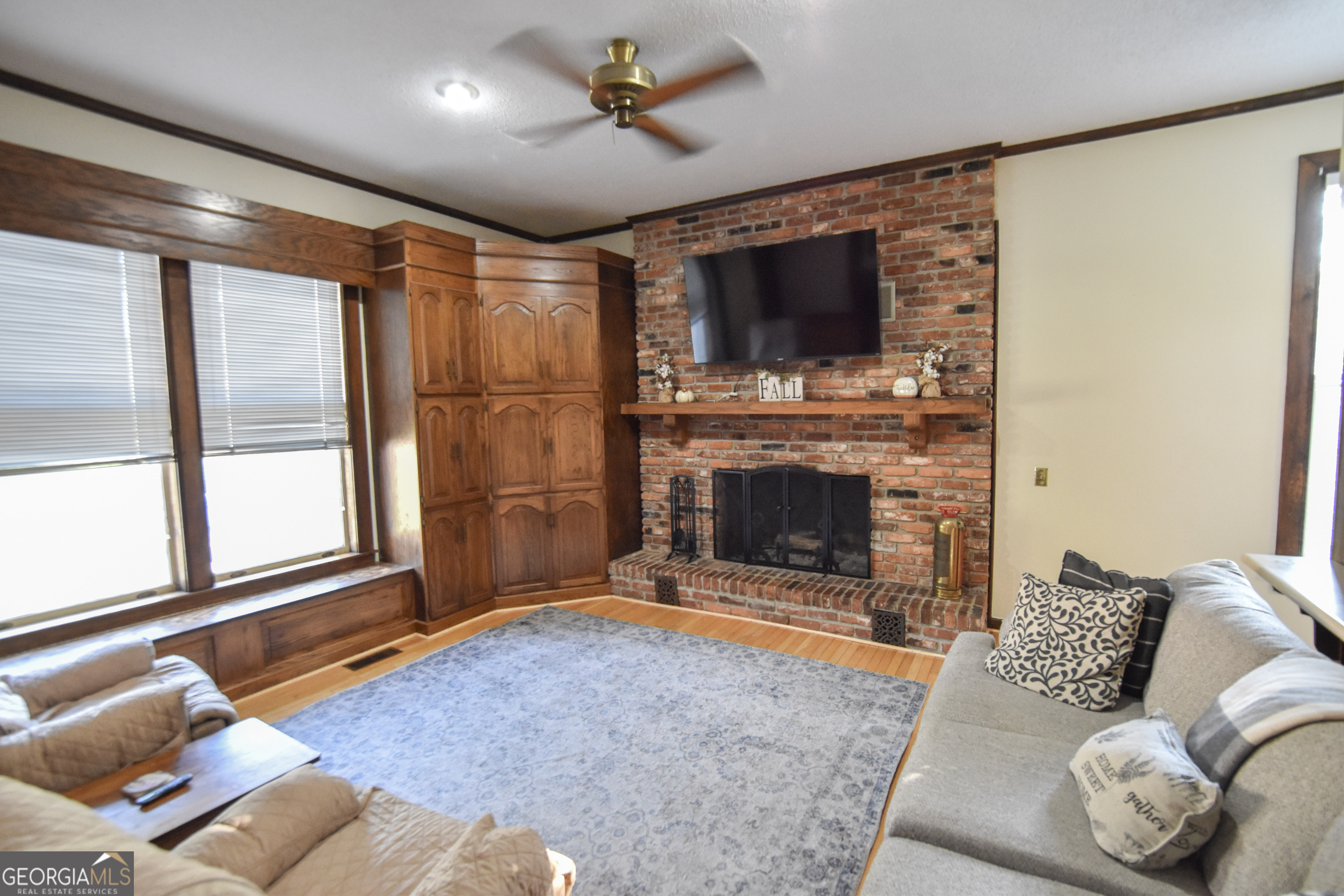 802 Mulberry Street Louisville, GA 30434 - Photo 37 of 51 a living room with furniture a flat screen tv and a fireplace