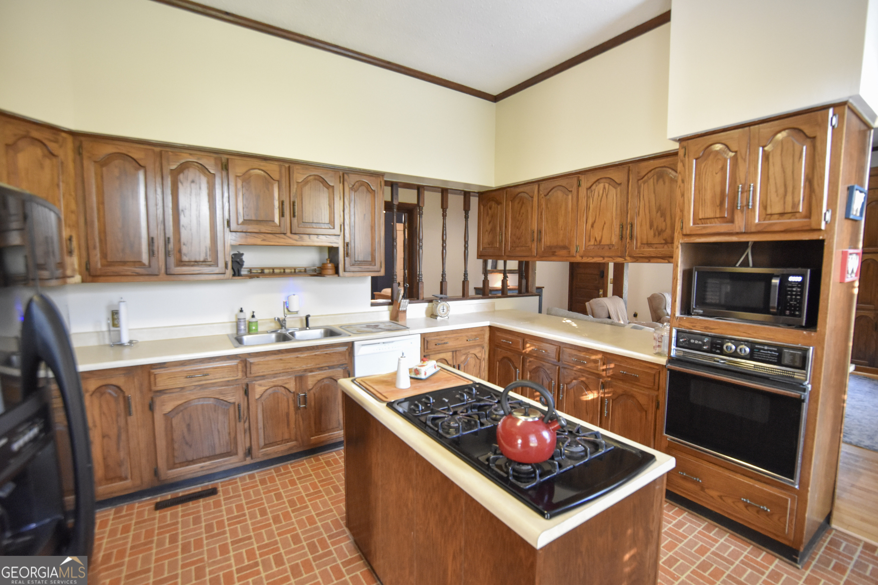 802 Mulberry Street Louisville, GA 30434 - Photo 39 of 51 a kitchen with granite countertop a stove top oven and cabinets