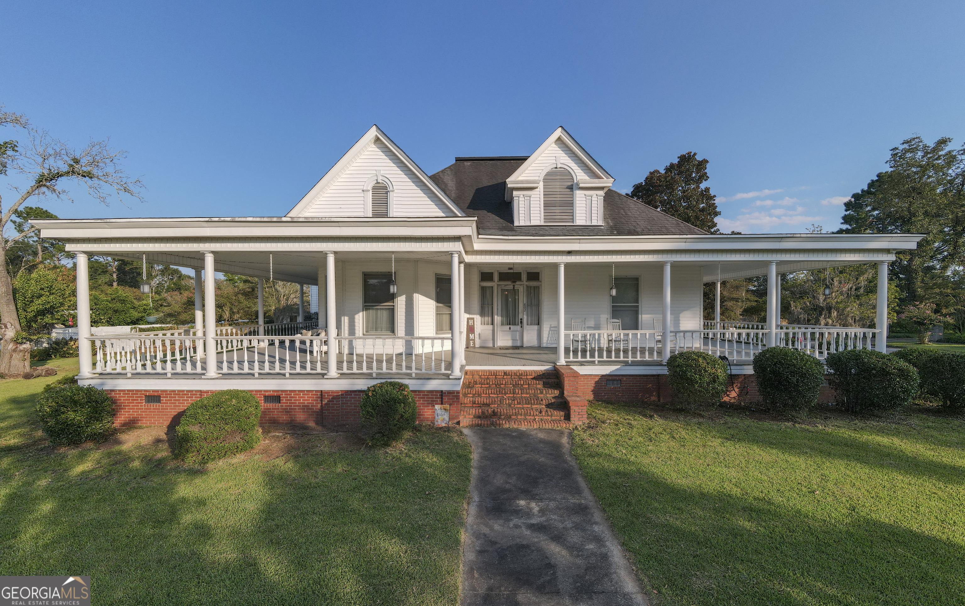 802 Mulberry Street Louisville, GA 30434 - Photo 41 of 51 a front view of a house with a yard table and chairs