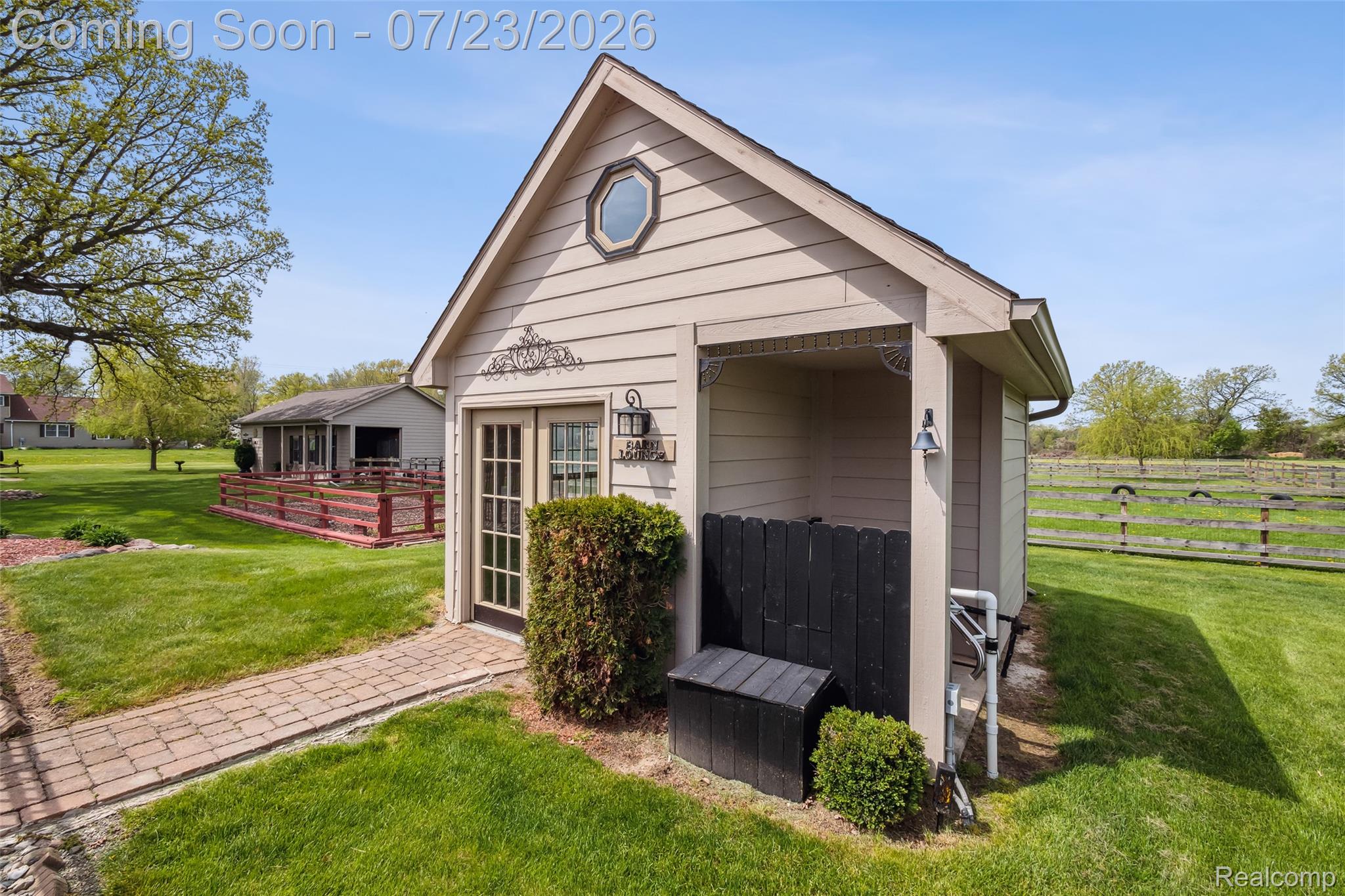 5460 Cochrane Road Almont, MI 48003 - Photo 39 of 48 Detached auxiliary structure featuring neutral siding, a front entry with French doors, an octagonal window, and an adjacent covered alcove