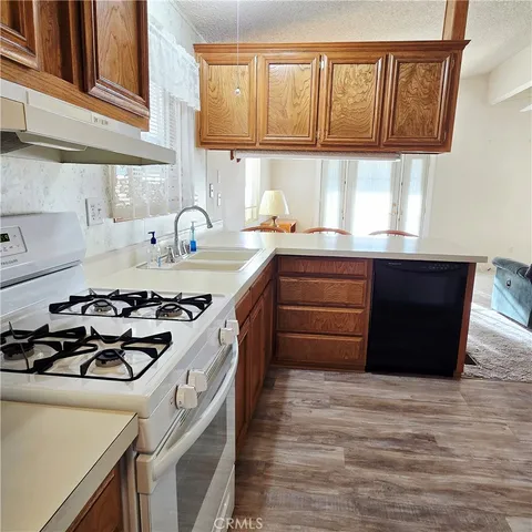 a kitchen with a refrigerator sink and cabinets