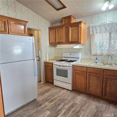 a kitchen with a refrigerator and a sink