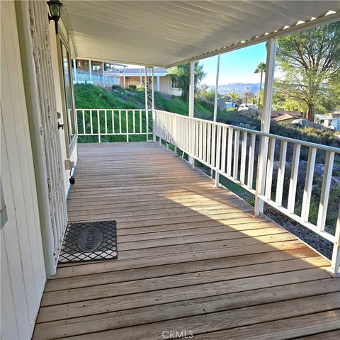 a view of a balcony with wooden floor