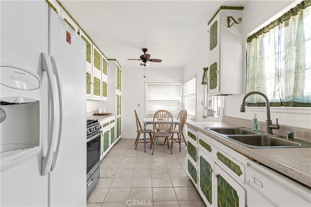 620 South Barclay Avenue Compton, CA 90220 - Photo 2 of 9 a kitchen with stainless steel appliances a sink a stove and a refrigerator