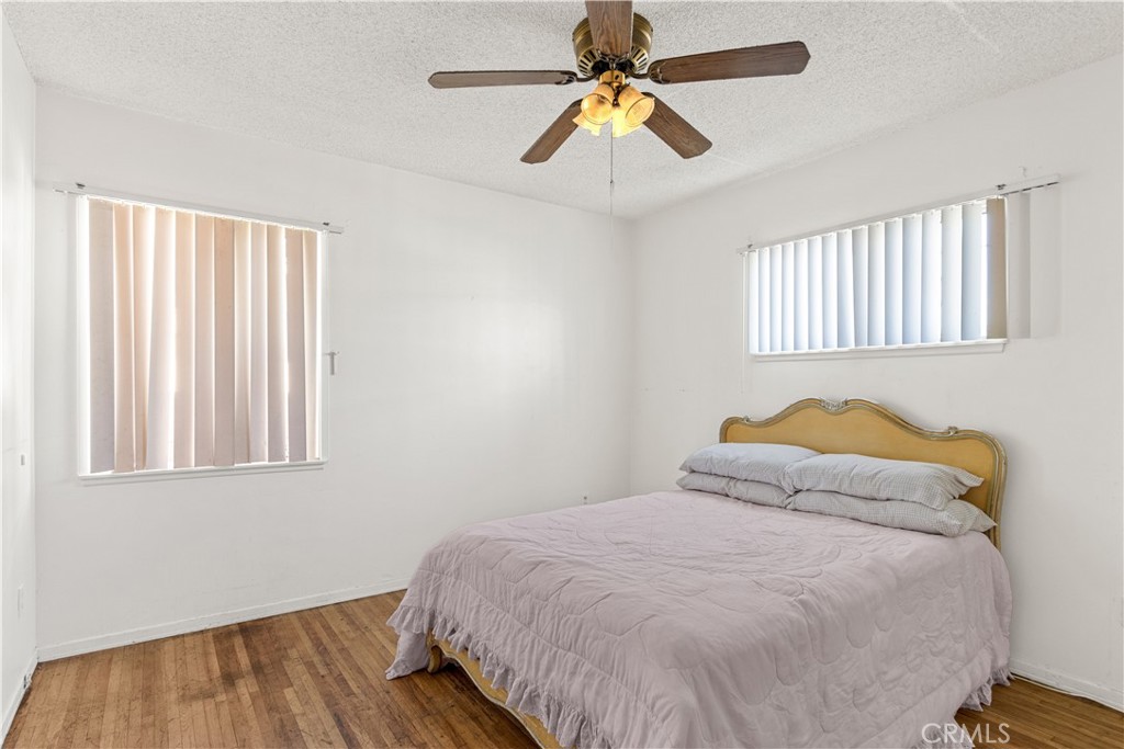 620 South Barclay Avenue Compton, CA 90220 - Photo 7 of 9 a bedroom with a bed and wooden floor