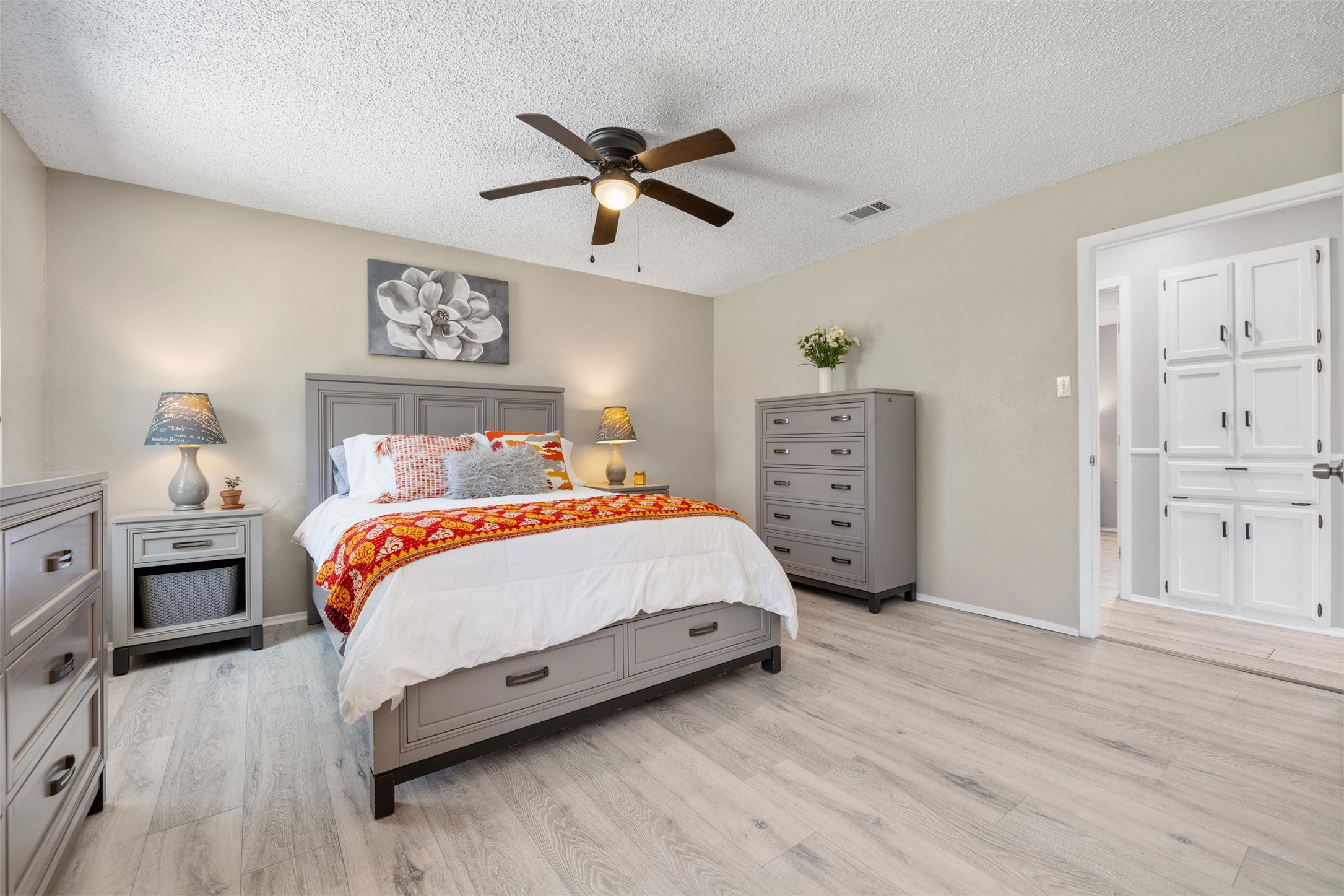 11302 Windermere Meadows Austin, TX 78759 - Photo 11 of 26 a bedroom with a bed and wooden floor