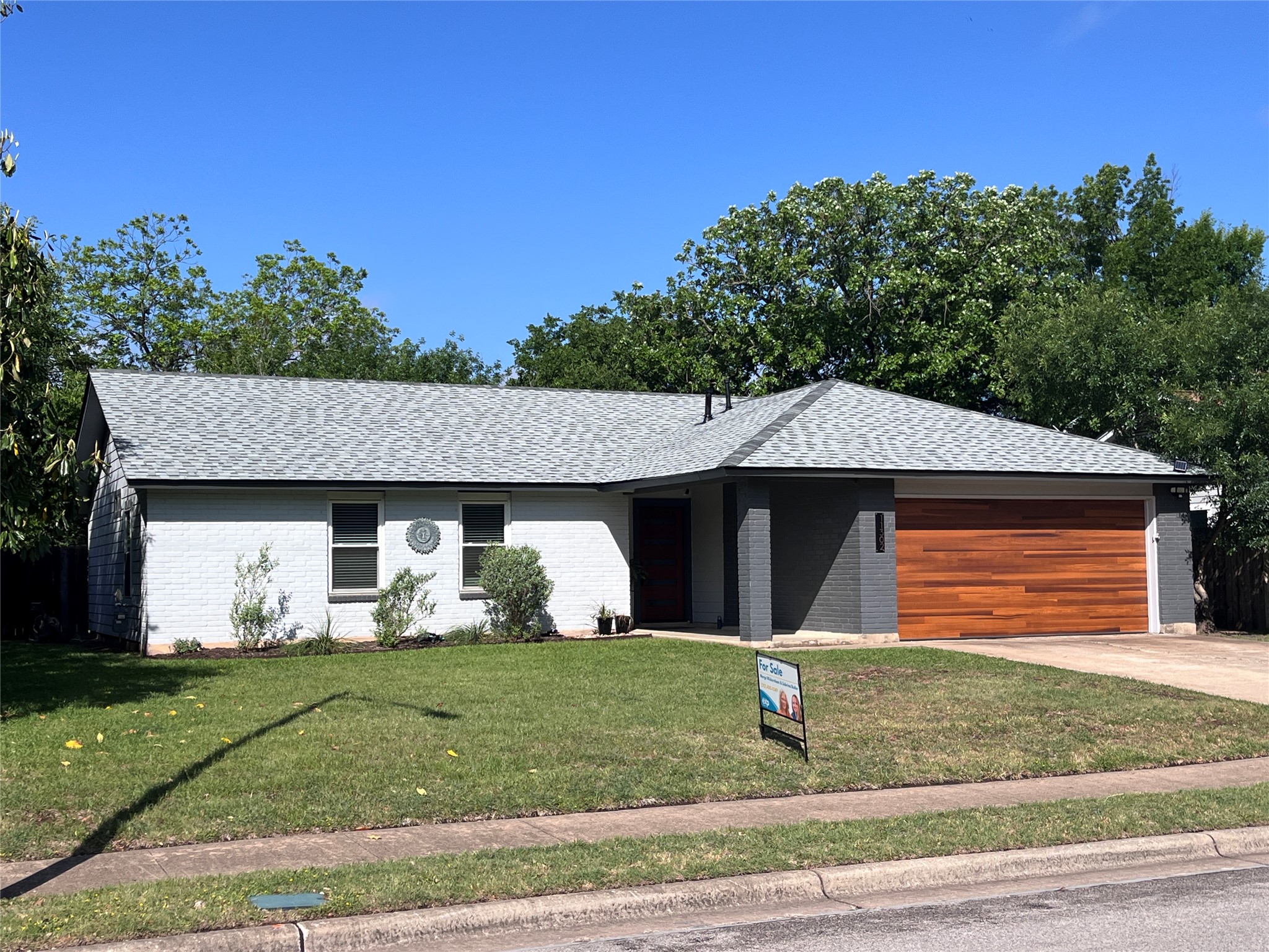 11302 Windermere Meadows Austin, TX 78759 - Photo 2 of 26 a front view of a house with a yard