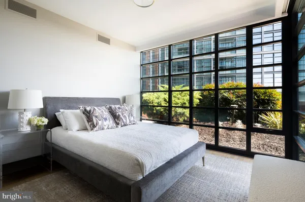 a bedroom with furniture and a large window