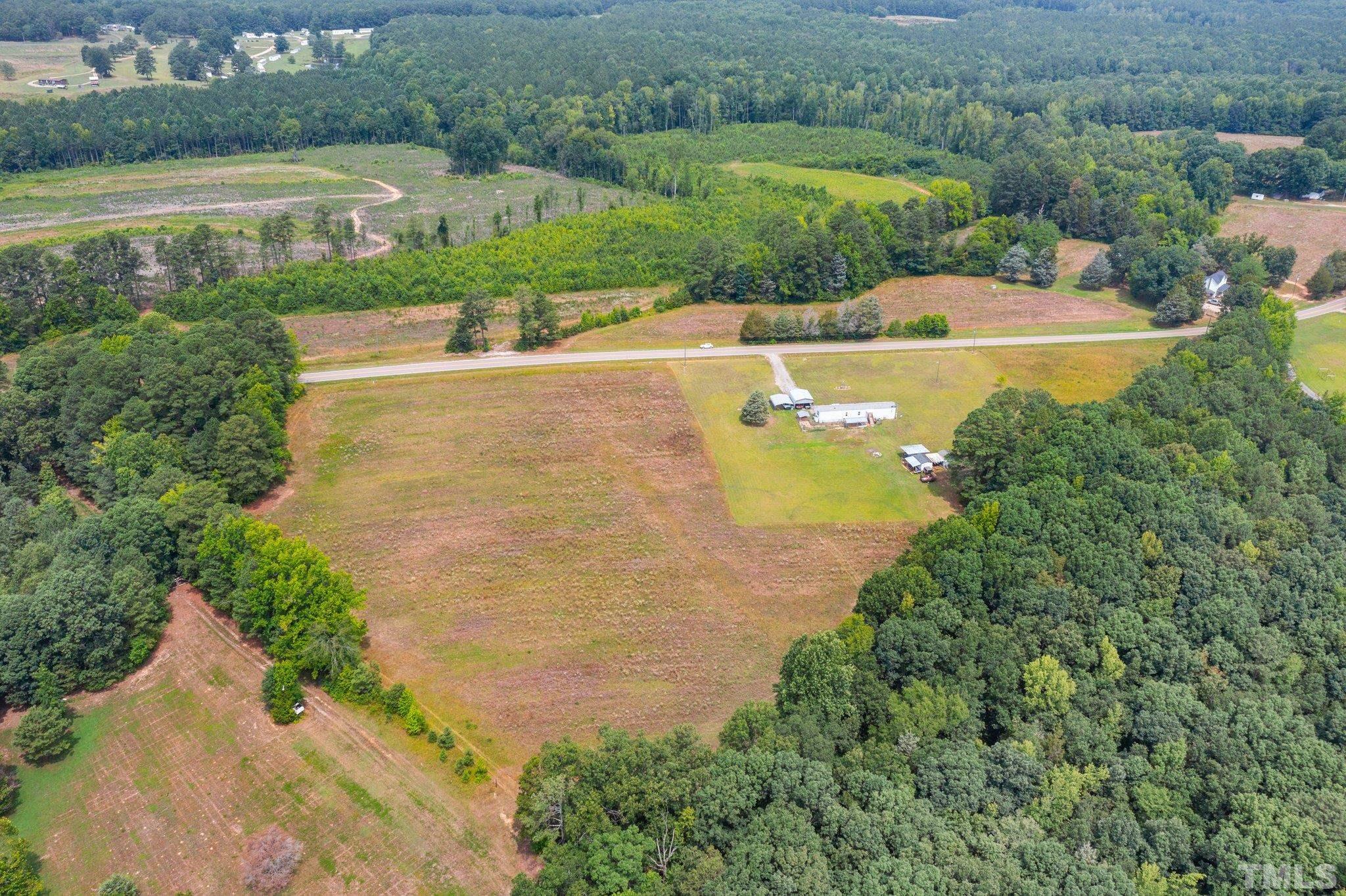 672 Green Hill Road Franklinton, NC 27525 - Photo 10 of 16 an aerial view of a house with a garden and lake view