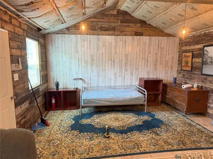 a living room with furniture a rug and a wooden floor