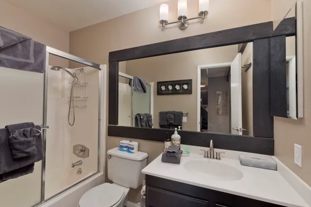 a bathroom with a sink toilet tub and shower