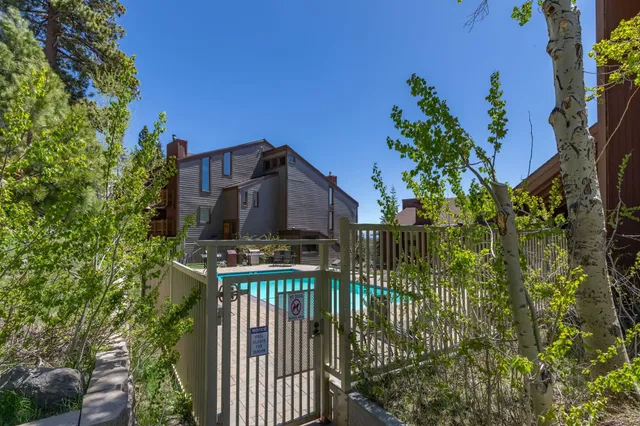 a view of a house with a small yard and plants