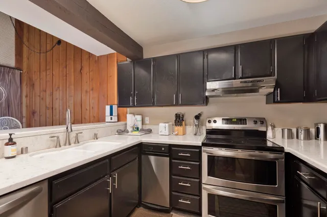 a kitchen with a sink stove and cabinets