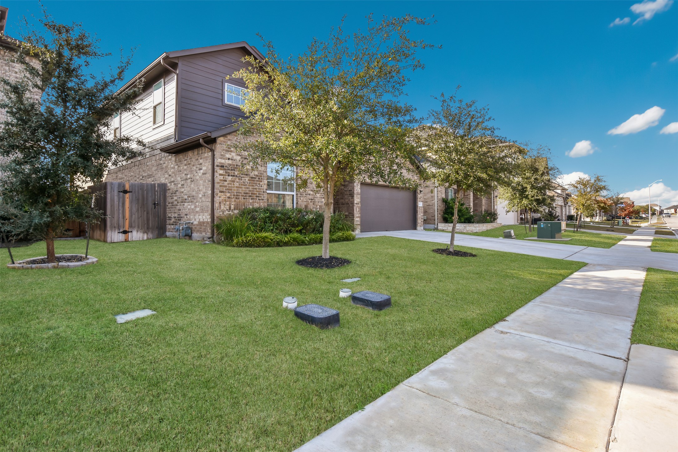 605 Oleander Loop Buda, TX 78610 - Photo 2 of 32 a front view of a house with garden and trees