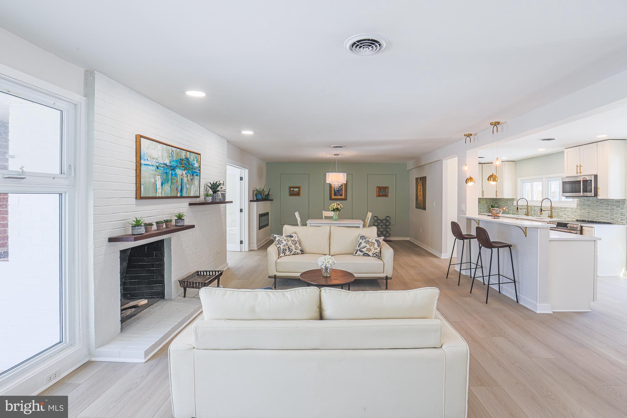 7900 Ivy Lane Baltimore, MD 21208 - Photo 3 of 34 a living room with furniture and a fireplace