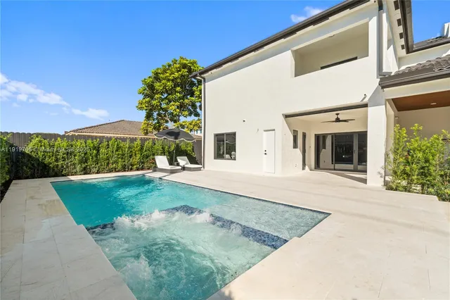 a living room with a large window and a potted plant