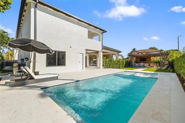 a view of a patio with chairs under an umbrella