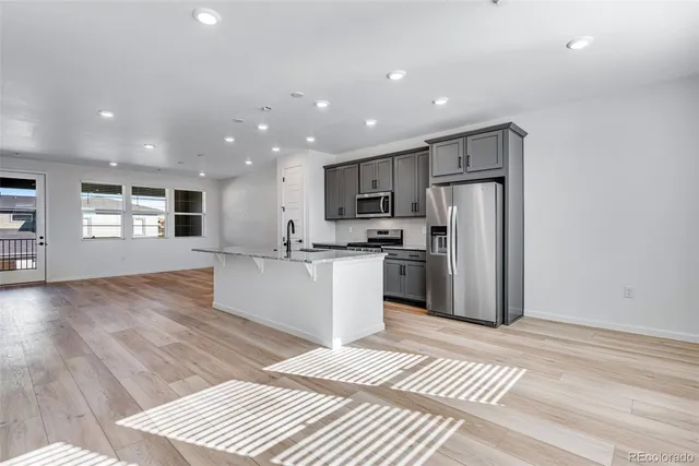 a kitchen with a refrigerator and a sink