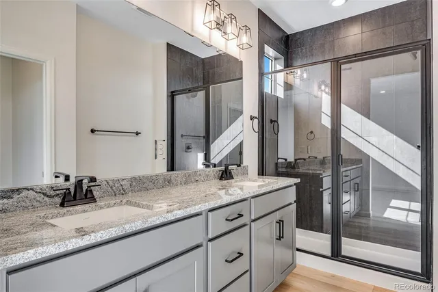 a bathroom with a granite countertop sink and a mirror