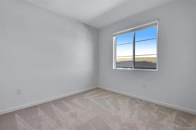 an empty room with closet area