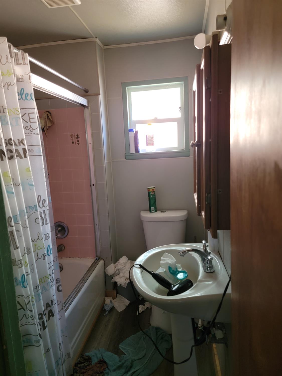 1024 E Street Reedley, CA 93654 - Photo 16 of 20 a bathroom with a sink toilet and shower