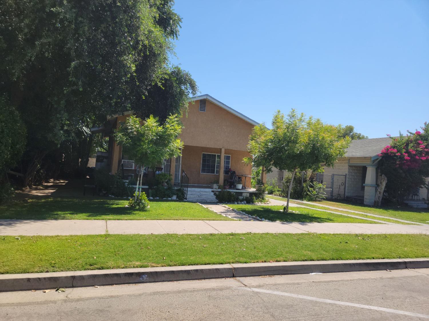 1024 E Street Reedley, CA 93654 - Photo 20 of 20 a house that has a tree in front of it