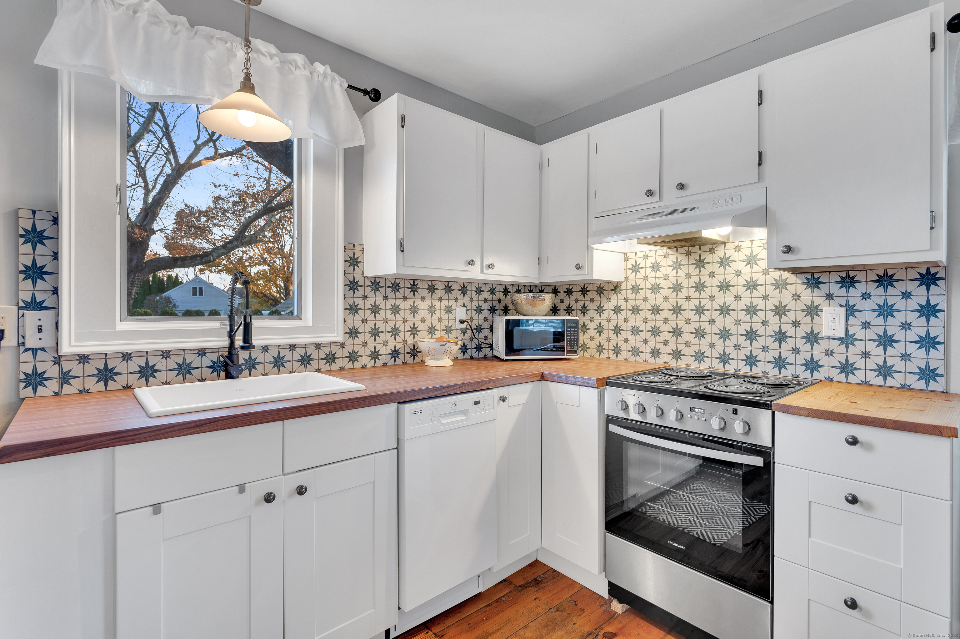 109 Salt Island Road Westbrook, CT 06498 - Photo 22 of 29 a kitchen with white cabinets and sink