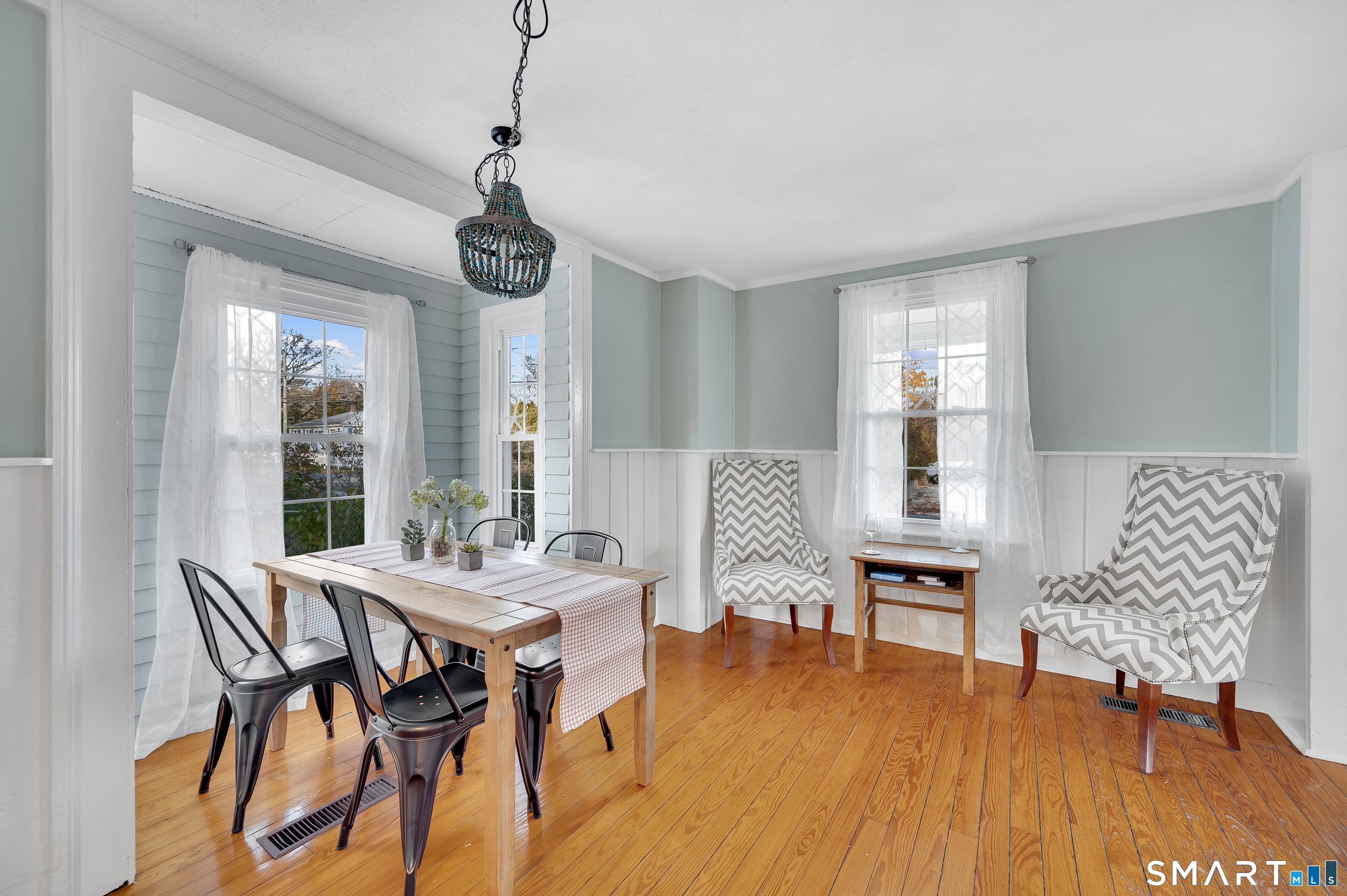 109 Salt Island Road Westbrook, CT 06498 - Photo 4 of 29 a view of a dining room with furniture window and wooden floor
