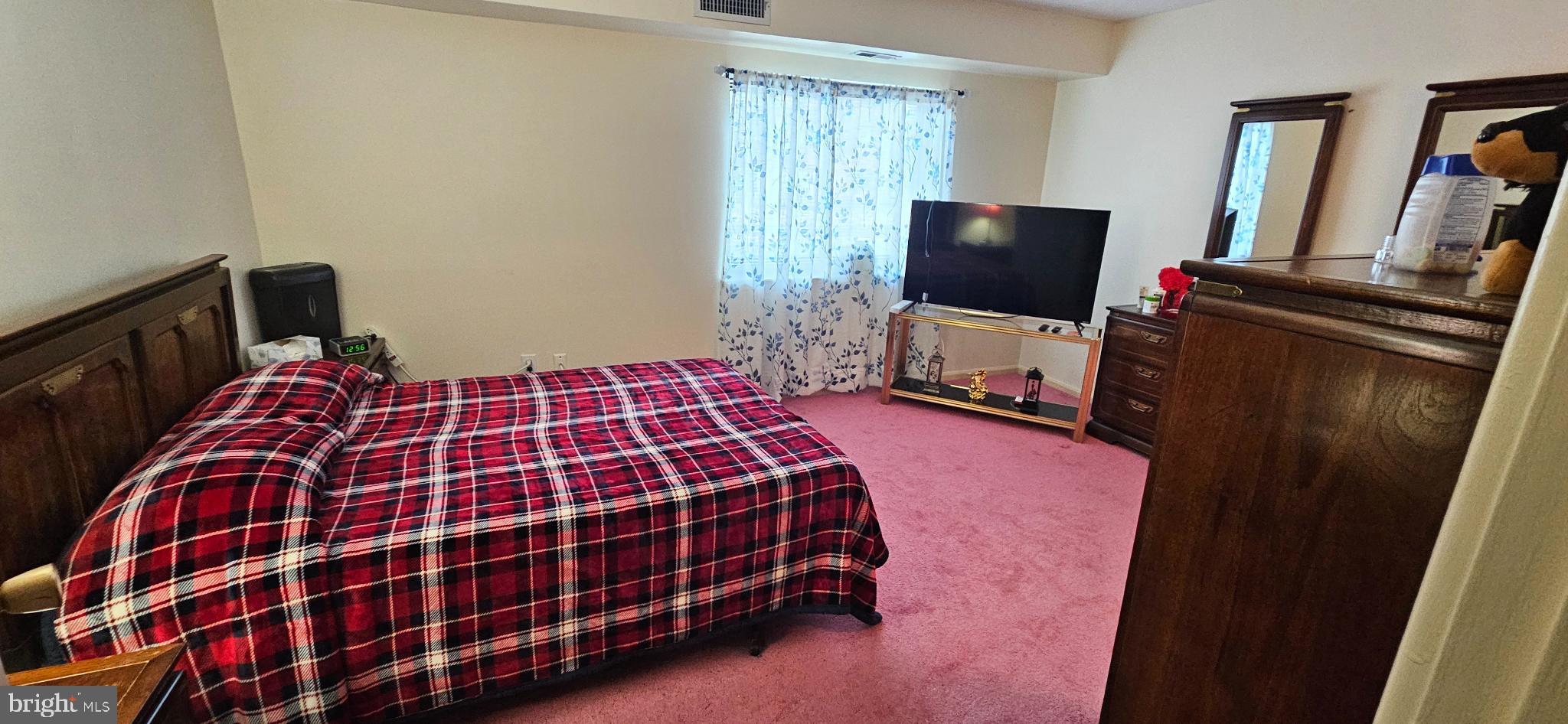 1101 Delaire Landing Road, Unit 101 Philadelphia, PA 19114 - Photo 13 of 29 Cozy bedroom with warm, inviting tones.