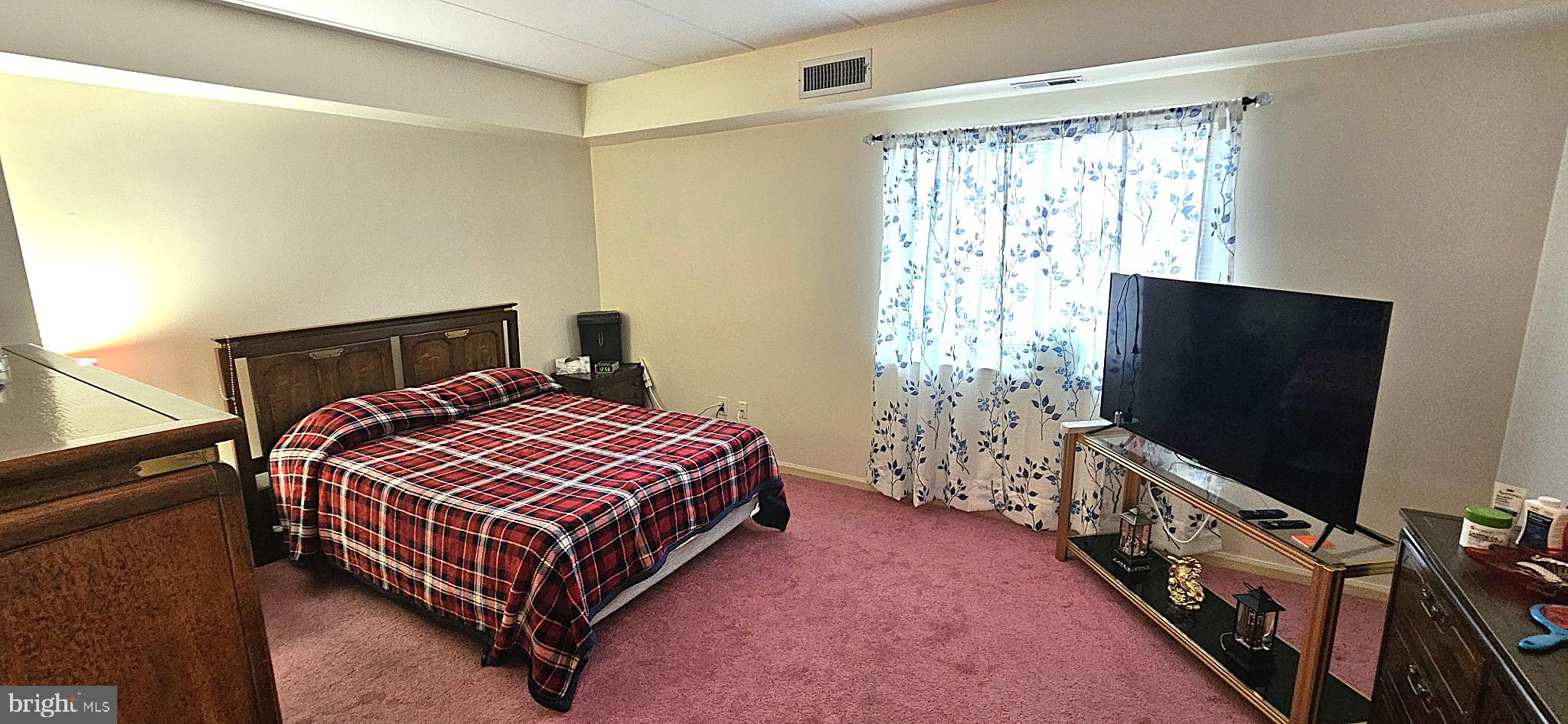 1101 Delaire Landing Road, Unit 101 Philadelphia, PA 19114 - Photo 14 of 29 Cozy bedroom with soft natural light.