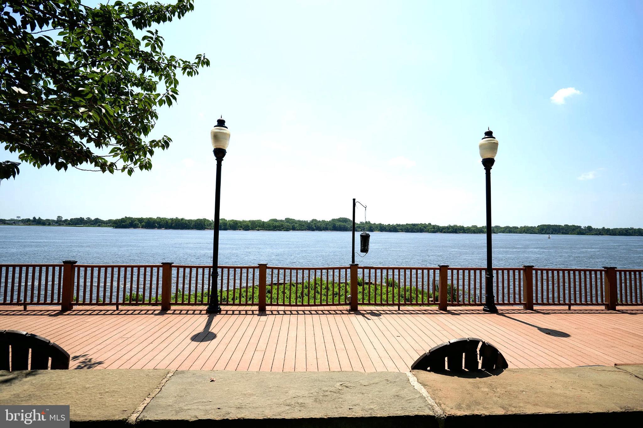 1101 Delaire Landing Road, Unit 101 Philadelphia, PA 19114 - Photo 21 of 29 Scenic riverside promenade under clear skies.