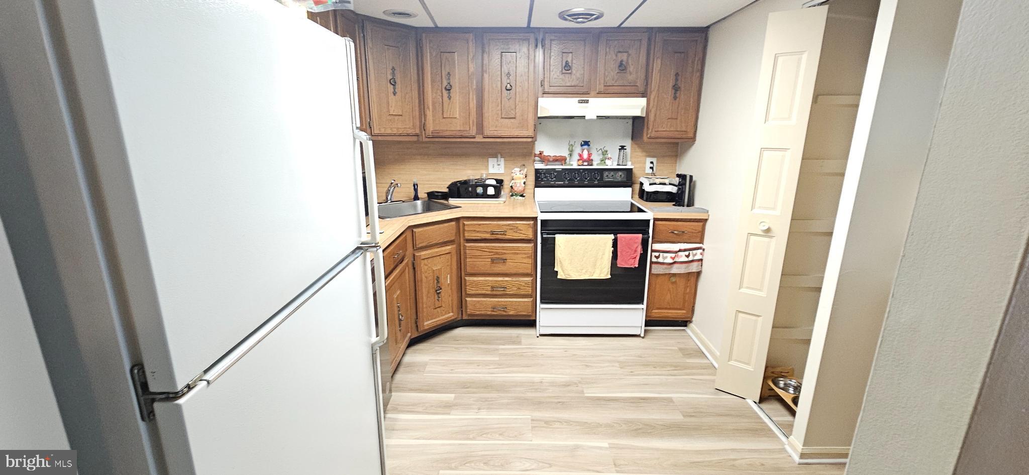 1101 Delaire Landing Road, Unit 101 Philadelphia, PA 19114 - Photo 8 of 29 Cozy kitchen with classic wooden cabinetry.