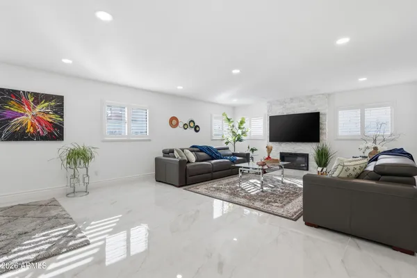 a view of a livingroom with a ceiling fan and window