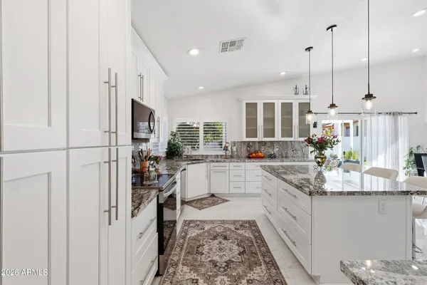 a bathroom with a granite countertop sink mirror and a toilet